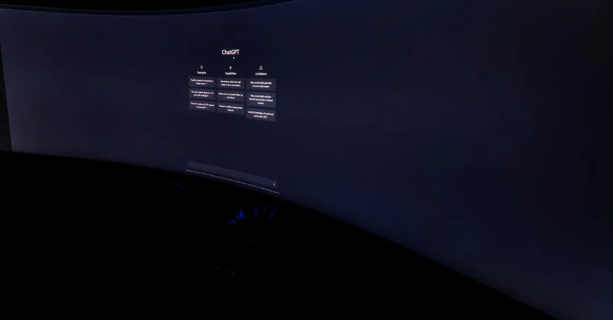 Curved monitor screen showing ChatGPT interface in low-light, focus on technology and AI.