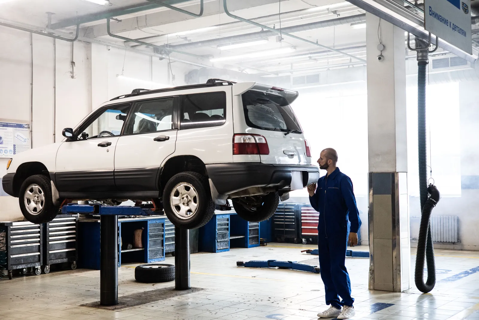 Modern auto repair garage with a car on a lift