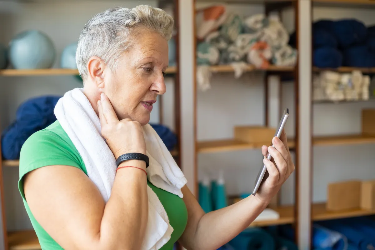 Gym member checking schedule on smartphone