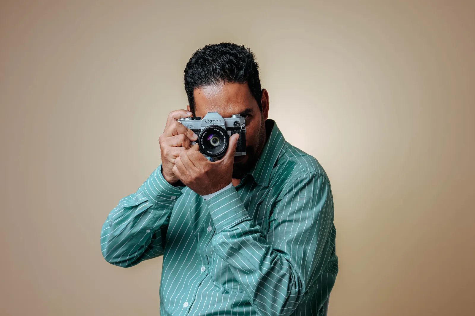 Photographer holding a camera in a studio