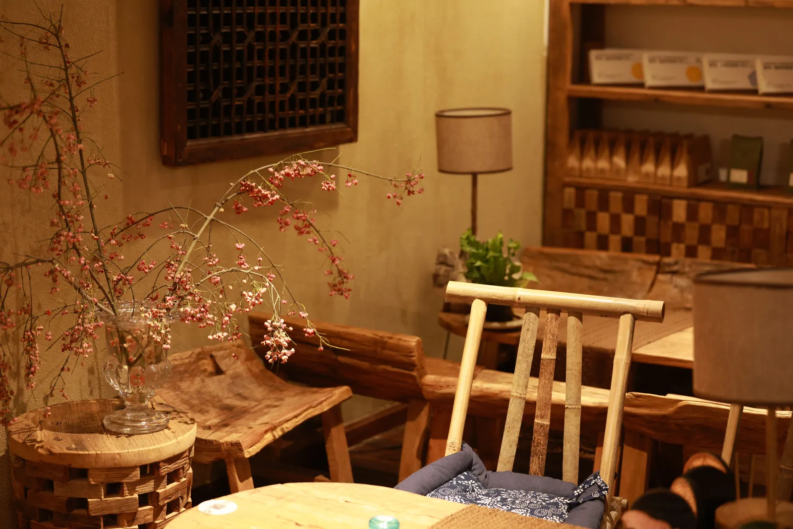 Cozy coffee shop interior with warm lighting and wooden tables