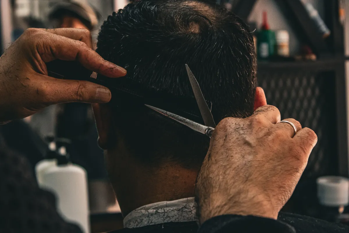 Hairstylist working with a client on a haircut